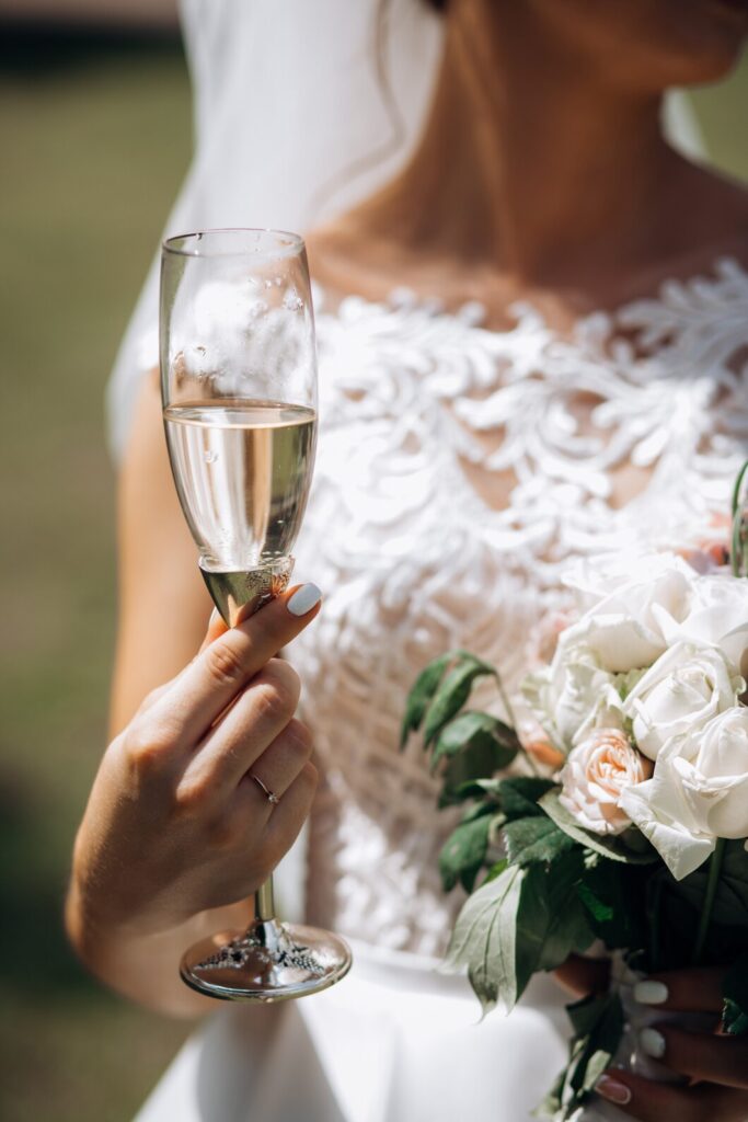 Bride is holding glass of champagne
